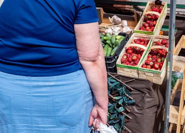 old woman on the vegetable market