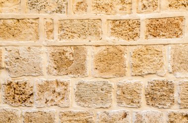 Antik taş duvar arka plan. Eski Jaffa İsrail'in antik taş duvar çalışması yaptı. Sert kumtaşı duvar doku.