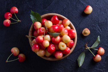 Siyah arka plan üzerine ahşap kase taze kiraz. Taze olgun tatlı kiraz. Yukarıda görmek, en iyi stüdyo vurdu