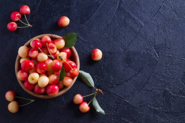 Siyah arka plan üzerine ahşap kase taze kiraz. Taze olgun tatlı kiraz. Yukarıda görmek, en iyi stüdyo vurdu
