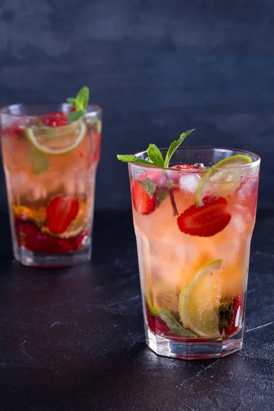 Çilek mojito çilek, limon ve nane ile kokteyl. Yaz meyve siyah arka plan üzerine kokteyl. dikey