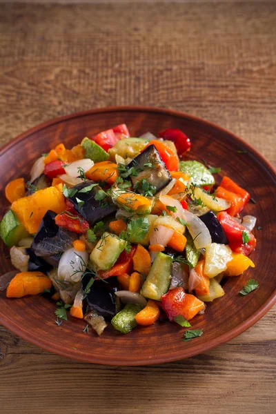 Vegetable stew: eggplant, pepper, tomato, zucchini, carrot and onion. Stewed vegetables salad. vertical