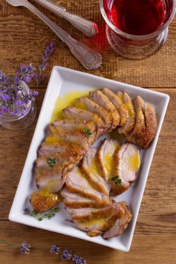 Beyaz tabakta Portakal soslu ördek göğsü. Ördek bonfile göğüs. Tepegöz, dikey