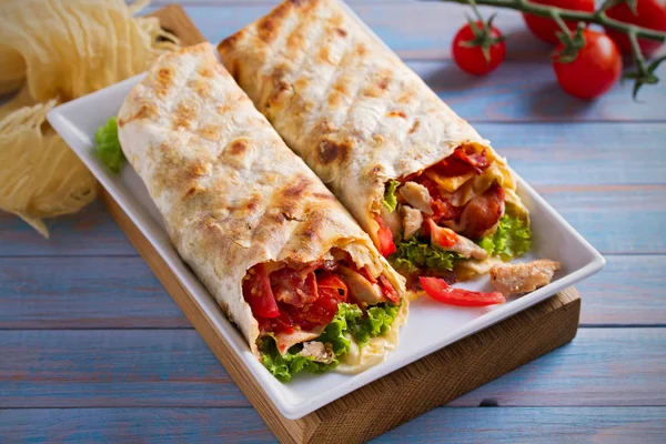 Chicken bacon wraps with tomatoes, lettuce and cheese. Tortilla, burritos, sandwiches twisted rolls. horizontal