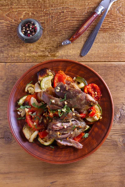 Slow cooker lamb with vegetables and garlic. View from above, top studio shot