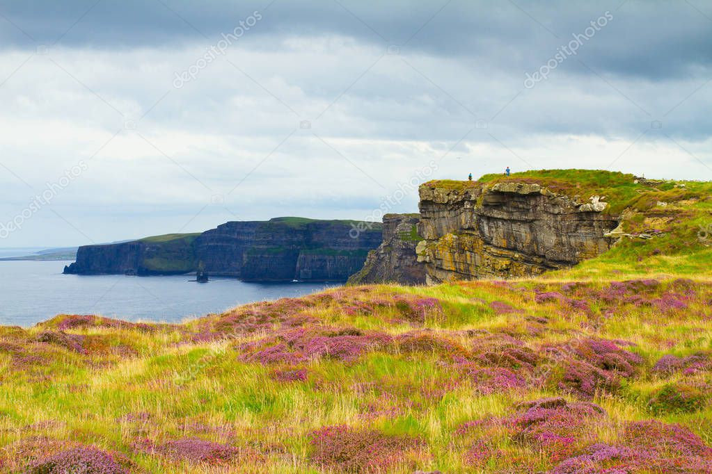 Photo of beautiful scenic sea and mountain landscape. Cliffs of Moher, west coast of Ireland, Atlantic ocean. View of ocean scenery