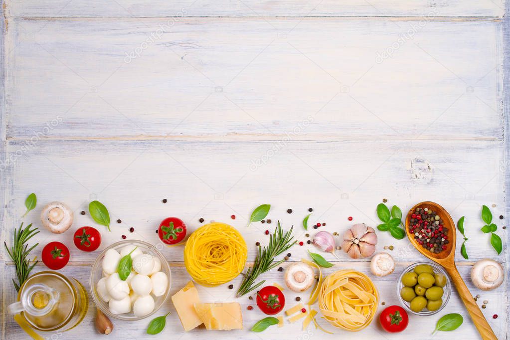 Italian food or ingredients with fresh vegetables, pasta, cheese mozzarella and parmesan, spices. Healthy food background. View from above, top studio shot