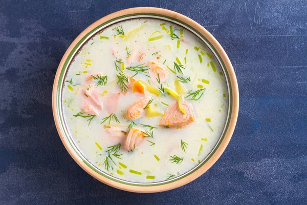 Salmon soup. Creamy hearty salmon fish soup. Clean eating, healthy and diet food concept. View from above, top studio shot