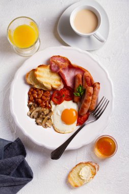 Tam İngilizce veya İrlandalı kahvaltı sosis, pastırma, yumurta, domates, mantar ve fasulye. Sabah besleyici ve sağlıklı yemek. Yukarıda görmek, en iyi stüdyo vurdu