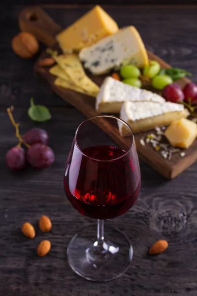 Glass Wine Cheese Grapes Nuts Black Wooden Table Wine Food — Stock Photo, Image