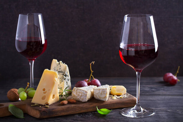 Red wine with cheese on chopping board. Wine and food concept - Image