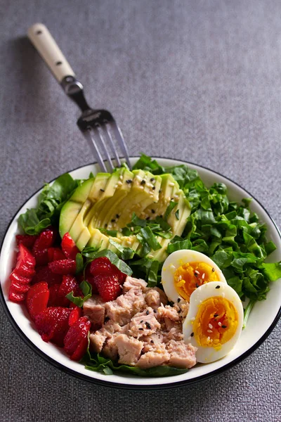 Tuna strawberries avocado egg and spinach salad. Tuna fish salad