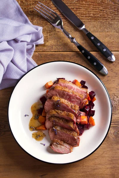 stock image Duck breast with lavender, beetroot, sweet potato and maple syrup. View from above, top studio shot