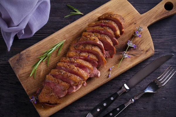 Duck breast on serving board. Duck breast fillet steak