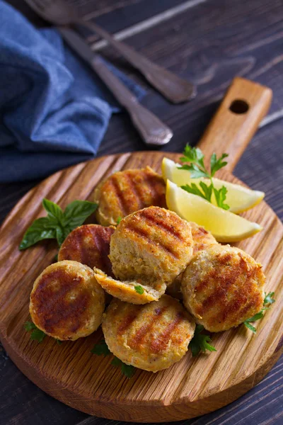 Fish cakes. Fish patties. Fried cutlets of minced fish on serving board