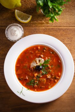 Solyanka - kalın, baharatlı ve ekşi Rus çorbası, sığır eti, jambon, sosis, tavuk göğsü salatalık turşusu ve domates yapılmış