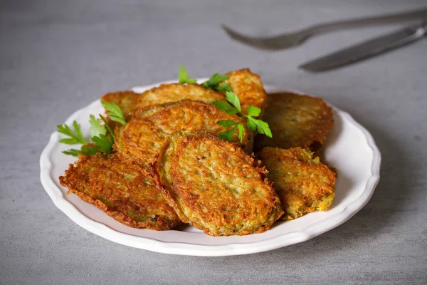 Potato cakes. Vegetable fritters, pancakes, latkes - dish consisting of pan fried shredded potatoes.