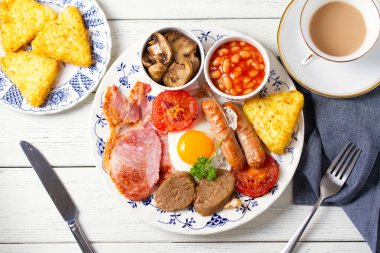 Klasik İrlanda ya da İngiliz kahvaltısı. Sosis, pastırma pastırması, puding, fasulye ve ızgara domates. Yüksek açı görünümü
