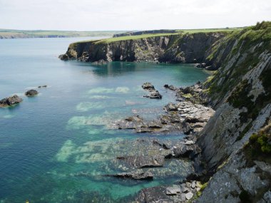 A wave cut platform below cliffs on the Pembrokeshire coast in South Wales, UK.