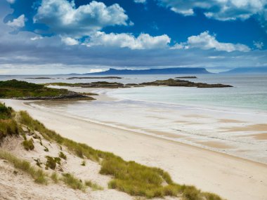 With the islands of Eigg and Rum on the horizon, a view across Camusdarach Beach on the west coast of Scotland - the beach featured  in the film Local Hero clipart