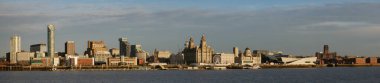 Liverpool's UNESCO listed waterfront including modern office buildings, the Church of Our Lady and Saint Nicholas, the Three Graces, the new Museum of Liverpool, Liverpool's Anglican Cathedral and historic dock warehouses.