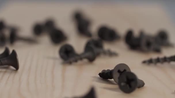 Black Iron Screws Fall Wooden Table Crumble Bouncing Slow Motion — Stock Video