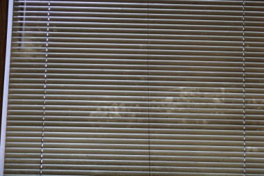 Extremely dirty window blinds in need of cleaning clipart