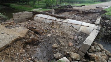 Road damage due to heavy rain and flash floods clipart