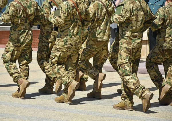 Soldiers are marching at the military parade