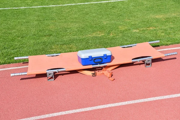 Strecher and medical kit next to the soccer field