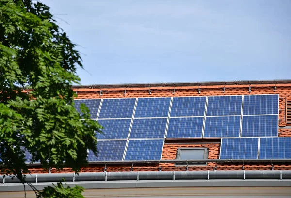 Solar panels on the roof of a building and trees