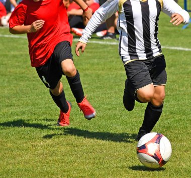 Genç çocuklar futbol oynuyor.