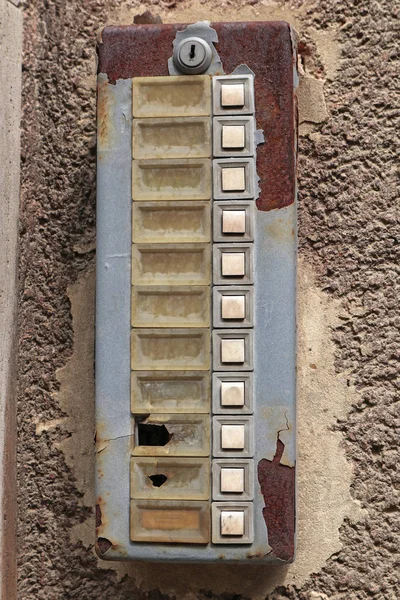 Old ruined dirty intercom on the wall Stock Photo