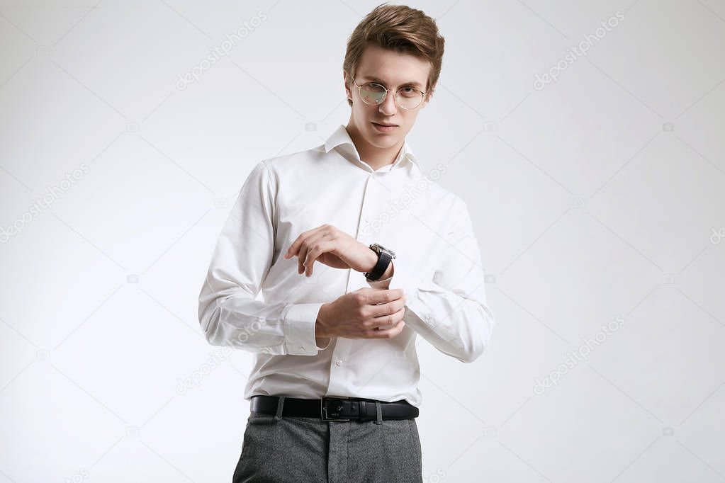 Confident young handsome businessman in shirt isolated on white background