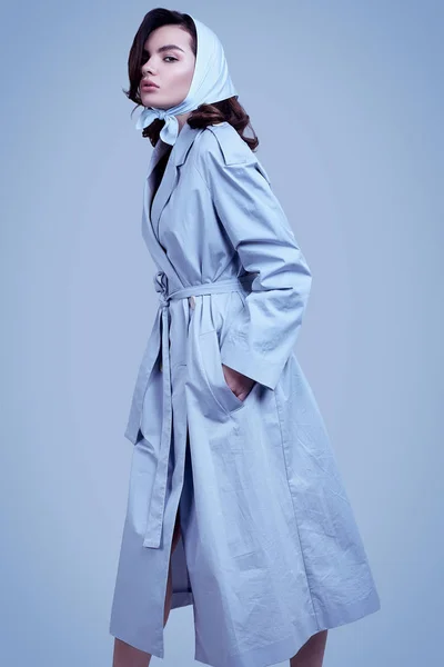 Young elegant brunette woman in coat and shawl posing in studio — 스톡 사진