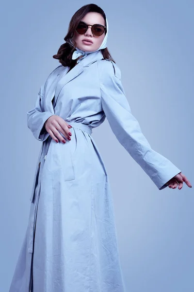 Young elegant brunette woman in coat and shawl posing in studio — 스톡 사진