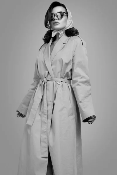 Fiatal elegáns barna nő kabátban és kendőben pózol a stúdióban — Stock Fotó