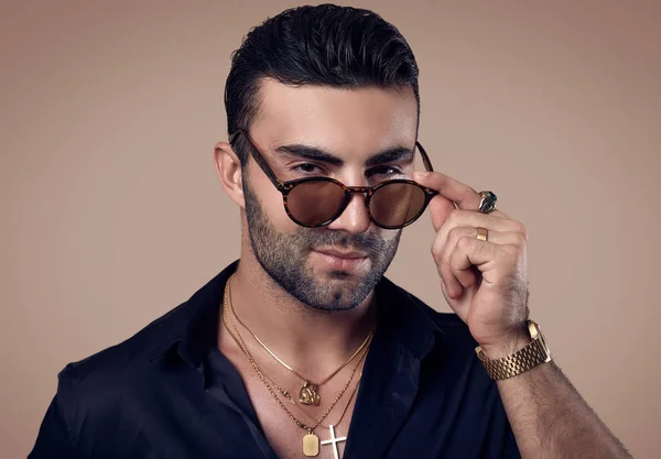 Beautiful brutal tanned hipster man in a black shirt and glasses — Stock Photo, Image