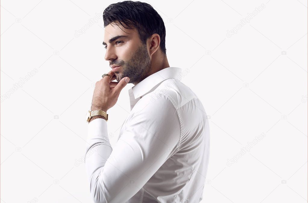 Beautiful brutal tanned businessman in a white shirt and sunglasses