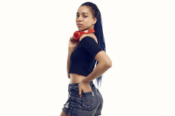 Beautiful african brunette teenage girl with dreadlocks listenin