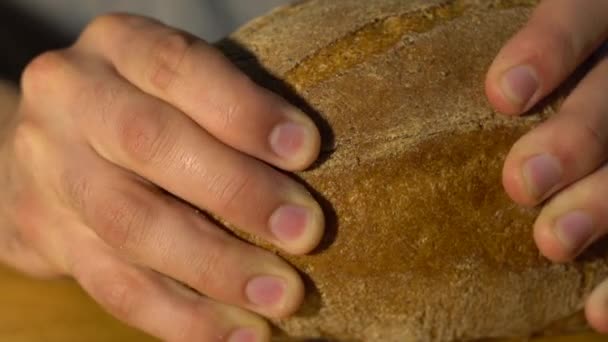 Biały Człowiek Piekarz Dzieli Chleb Żytni Dwie Części Zbliżenie Chleba — Wideo stockowe