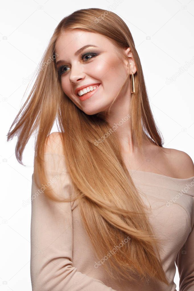 Beautiful blond girl with a perfectly smooth hair, classic make-up. Beauty face