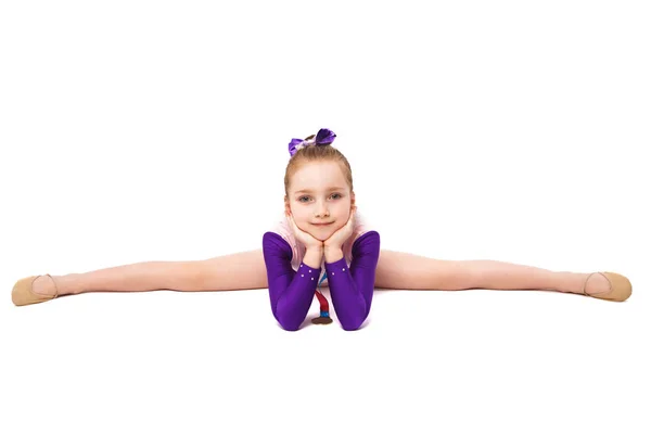 Little girl gymnast with a medal in a sports swimsuit doing exercises — Stock Photo, Image