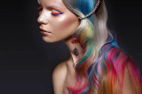 Mooi meisje met veelkleurig haar en creatieve make-up en kapsel. Schoonheidsgezicht. — Stockfoto