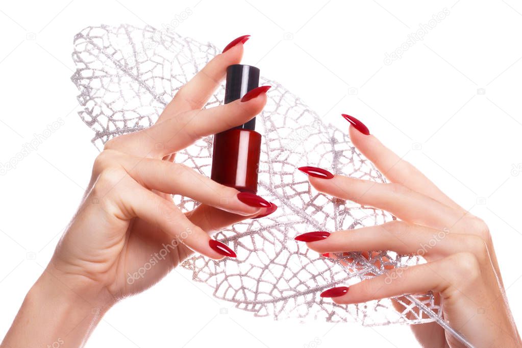 Bright festive red manicure on female hands. Nails design