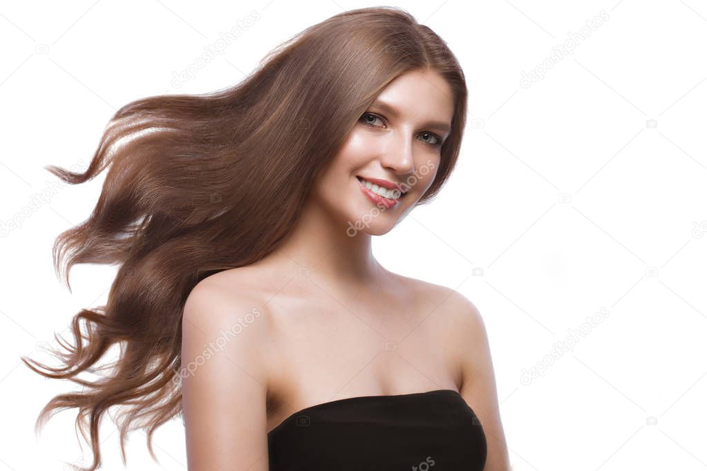 Beautiful brown-haired girl in move with a perfectly curls hair, and classic make-up. Beauty face.