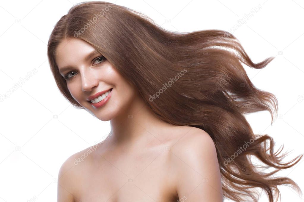 Beautiful brown-haired girl in move with a perfectly curls hair, and classic make-up. Beauty face.