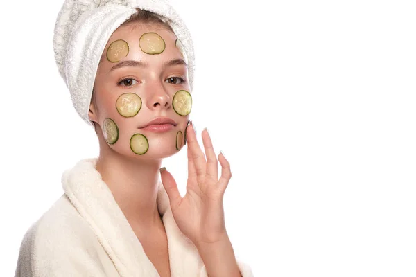 Mooi teder jong meisje in een witte handdoek met schone frisse huid poseren voor de camera met een masker van komkommers op het gezicht. Schoonheidsgezicht. Huidverzorging. — Stockfoto