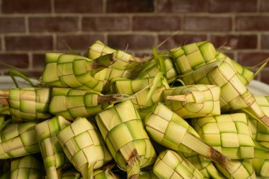Ketupat (pirinç köftesi), Güneydoğu Asya 'da bayram döneminde, özellikle bayramlarda yerel bir lezzettir. Genç hindistan cevizi yapraklarından yapılmış doğal bir pirinç kabı. Seçici Odak.