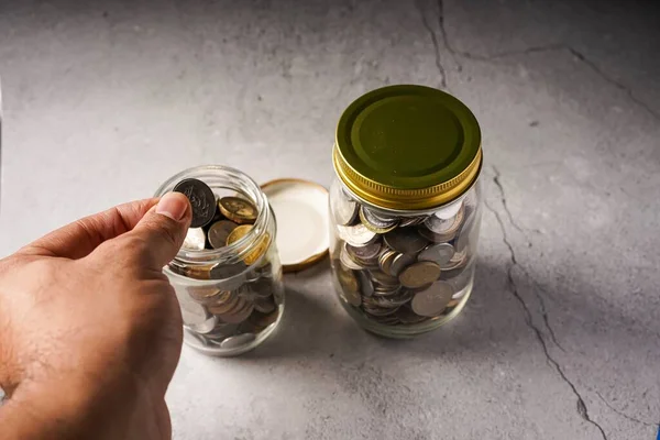 Savings concept: coins in jar with copy space for text